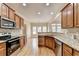 Spacious kitchen featuring hardwood floors, stainless appliances, granite countertops, and ample cabinet space at 106 Little Barley Ln, Grayson, GA 30017