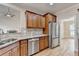 Well-lit kitchen features stainless steel appliances, granite countertops, and hardwood flooring at 106 Little Barley Ln, Grayson, GA 30017