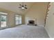 Bright living room with fireplace, vaulted ceiling, large windows and access to deck at 106 Little Barley Ln, Grayson, GA 30017