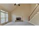 Cozy living room with stone fireplace, high ceilings, and staircase at 106 Little Barley Ln, Grayson, GA 30017