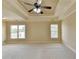 Spacious main bedroom with tray ceiling, ceiling fan, neutral paint and carpet, and large windows at 106 Little Barley Ln, Grayson, GA 30017