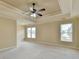 Spacious main bedroom with tray ceiling, ceiling fan, neutral paint and carpet, and large windows at 106 Little Barley Ln, Grayson, GA 30017