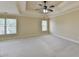 A spacious main bedroom features a tray ceiling, neutral walls and carpet, with natural light from windows at 106 Little Barley Ln, Grayson, GA 30017