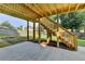 Backyard patio featuring stairs leading to a raised deck and a well manicured lawn at 106 Little Barley Ln, Grayson, GA 30017