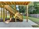 Backyard patio featuring stairs leading to a raised deck and a well manicured lawn at 106 Little Barley Ln, Grayson, GA 30017