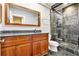 Bathroom features a dark stone tiled shower, wooden vanity, and decorative mirror at 1156 Piedmont Ne Ave # B3, Atlanta, GA 30309