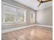 Bright room with hardwood floors, modern ceiling fan, and multiple windows at 1156 Piedmont Ne Ave # B3, Atlanta, GA 30309