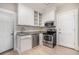 Compact kitchen featuring stainless steel appliances, white cabinets, and light granite countertops at 1156 Piedmont Ne Ave # B3, Atlanta, GA 30309