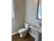 Half bathroom features a pedestal sink, mirror and hardwood floors at 274 Lakeside Pl, Canton, GA 30114