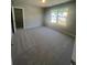 Neutral bedroom with a large window and carpet floors at 274 Lakeside Pl, Canton, GA 30114