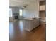 Open concept living room with a kitchen island, fireplace and hardwood floors at 274 Lakeside Pl, Canton, GA 30114
