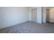 Bedroom with neutral colored walls, plush carpeting, and large door leading to hallway at 325 Forkview Dr, Lawrenceville, GA 30044