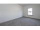 Neutral bedroom featuring plush carpeting, neutral paint and large window at 325 Forkview Dr, Lawrenceville, GA 30044