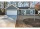 Charming single-Gathering home with a two-car garage and beautifully manicured front yard at 325 Forkview Dr, Lawrenceville, GA 30044