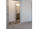 View of an empty bedroom hall featuring gray paint and dark wood floors, leading to the bathroom at 325 Forkview Dr, Lawrenceville, GA 30044