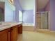 Spacious bathroom features a tub, separate shower, sink with cabinets, and tile flooring at 1421 Gates Se Cir, Atlanta, GA 30316