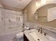 Elegant bathroom featuring a marble vanity, oval mirror, and tiled shower at 1421 Gates Se Cir, Atlanta, GA 30316