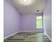 Inviting bedroom with light purple walls, window, and wood-look flooring at 1421 Gates Se Cir, Atlanta, GA 30316