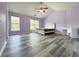 Spacious bedroom featuring hardwood floors, a ceiling fan, and plenty of natural light from the windows at 1421 Gates Se Cir, Atlanta, GA 30316