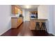Eat-in kitchen features wood cabinets, granite countertops, island with bar stools, and hardwood floors at 1421 Gates Se Cir, Atlanta, GA 30316