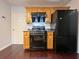 Well-equipped kitchen with dark appliances, wooden cabinets, and hardwood floors at 1421 Gates Se Cir, Atlanta, GA 30316