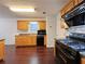 Efficient kitchen features wooden cabinets, black appliances and hardwood floor at 1421 Gates Se Cir, Atlanta, GA 30316