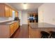 Kitchen features wood cabinets, granite countertops, island with stools, and hardwood floors at 1421 Gates Se Cir, Atlanta, GA 30316