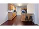 View of an open kitchen with bar seating, wood cabinets, and access to dining area at 1421 Gates Se Cir, Atlanta, GA 30316