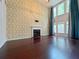 Bright living room with tall ceilings, statement wallpaper, and a cozy fireplace at 1421 Gates Se Cir, Atlanta, GA 30316