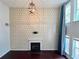 Stunning living room with a fireplace, geometric-patterned accent wall, and floor to ceiling windows at 1421 Gates Se Cir, Atlanta, GA 30316