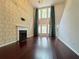 Open living room with fireplace, large windows with curtains, and hardwood floors at 1421 Gates Se Cir, Atlanta, GA 30316