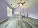Bright main bedroom with sloped ceiling, wood-look floors, ceiling fan and a desk at 1421 Gates Se Cir, Atlanta, GA 30316