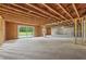 Unfinished basement with sliding door leading to the backyard at 1255 E M Croy Rd, Sugar Hill, GA 30518