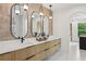 Bright bathroom featuring double vanity, modern fixtures, elegant mirrors, and plenty of drawer space at 1255 E M Croy Rd, Sugar Hill, GA 30518