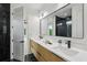 A modern bathroom features a double vanity, black fixtures, and a view to the shower at 1255 E M Croy Rd, Sugar Hill, GA 30518