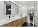 A modern bathroom with a double vanity, sleek black fixtures, and a view to the outside at 1255 E M Croy Rd, Sugar Hill, GA 30518
