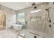 Spa-like bathroom with a soaking tub, walk-in shower, and marble accents at 1255 E M Croy Rd, Sugar Hill, GA 30518