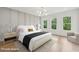 Bright bedroom with hardwood floors, three large windows, and neutral decor at 1255 E M Croy Rd, Sugar Hill, GA 30518