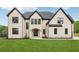 Elegant exterior with manicured lawn and large windows, showcasing a classic design at 1255 E M Croy Rd, Sugar Hill, GA 30518