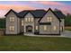 Front exterior showcasing a well-manicured lawn and elegant brick facade at 1255 E M Croy Rd, Sugar Hill, GA 30518