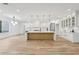 Gourmet kitchen with large island, modern lighting, seating and views of the breakfast area at 1255 E M Croy Rd, Sugar Hill, GA 30518