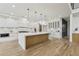 Modern kitchen with large waterfall island, stainless steel appliances and custom cabinets with accent lighting at 1255 E M Croy Rd, Sugar Hill, GA 30518