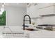 Gourmet kitchen featuring an island with pop-up outlet charging stations and modern appliances at 1255 E M Croy Rd, Sugar Hill, GA 30518