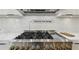 Close-up of the six burner gas range in a modern kitchen, perfect for culinary enthusiasts at 1255 E M Croy Rd, Sugar Hill, GA 30518