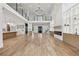 Bright open-plan living space features a fireplace, high ceilings and an open staircase to the second story at 1255 E M Croy Rd, Sugar Hill, GA 30518