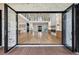 Grand living room features a soaring ceiling, hardwood floors, and an elegant fireplace at 1255 E M Croy Rd, Sugar Hill, GA 30518