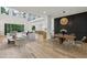 Bright open-plan living space features a cozy seating area and adjacent dining area with statement lighting fixture at 1255 E M Croy Rd, Sugar Hill, GA 30518