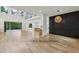 Spacious living room with white oak hardwood floors, large windows, and open access to an outdoor balcony at 1255 E M Croy Rd, Sugar Hill, GA 30518