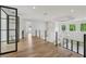 Bright upper loft with hardwood floors, glass railing, and large windows offering scenic views at 1255 E M Croy Rd, Sugar Hill, GA 30518