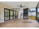 Covered outdoor patio with retractable doors, composite decking, and a cozy stone fireplace at 1255 E M Croy Rd, Sugar Hill, GA 30518